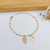 PULSEIRA DE BOLINHA COM 1 MENINA E CORAÇÃO COM INICIAL VAZADA BANHADO A OURO 18K - comprar online