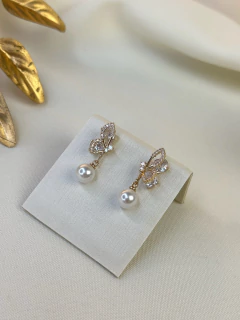 Brinco borboleta pérola BRIMU15 na internet