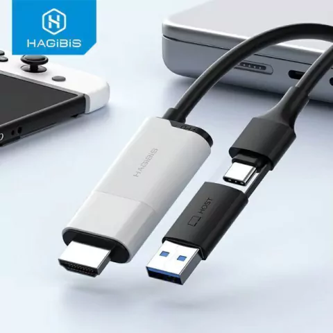 Placa de captura de vídeo branca com cabo 2 em 1 e conectores USB e HDMI próximos a dispositivos eletrônicos