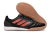 Chuteira futsal Adidas modelo Competition top IC, com detalhes em preto e laranja, ideal para jogos em quadra.