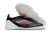 Chuteira Futsal Adidas F50 PRO TF na cor preta com detalhes em vermelho e branco, ideal para jogos de society.
