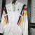 JAQUETA CORTA VENTO SELEÇÃO ALEMANHA 24/25 ADIDAS-MASCULINA- BRANCA