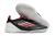 Chuteira futsal Adidas F50 PRO IC com design preto e detalhes em vermelho.