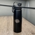 Garrafa preta inox com tampa e alça - all back óculos atacado