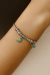 Bracelete em aço na cor prata com berloques verde - comprar online