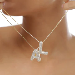 Colar banhado a Ouro 18k, com pingente cravejado em zircônias em formato de letra.