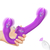 Vibrador triplo em forma de strap-on, na cor roxa, com detalhes em branco e controle remoto, sendo segurado por uma mão.
