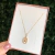 COLAR OVAL LETRA CRISTAL