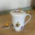 Imagem do CONJUNTO CANECA EM PORCELANA COM TAMPA E INFUSOR DE CHÁ COM CAIXA DE PRESENTE