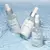 Frascos de Aqua Sérum Hidratação Intensiva 30ml da Adcos, dispostos sobre uma superfície aquática.