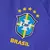 Camisa reserva azul da Seleção Brasileira feminina 2022 com estampa de jaguatirica nas mangas e gola arredondada verde