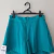 Short azul turquesa zíper frente alfa na internet