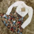 BODY LISO DECOTE/ COM TRIANGULO DE STRASS( COM BOJO)