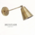 Aplique de pared Petit en dorado viejo con movimientos verticales en dos sectores