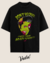 Camiseta oversized preta com estampa de um zumbi inspirado em Elvis Presley, com o texto "Don't be cruel" e "I need your brain tonight!" em cores vibrantes.