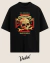 Black oversized T-shirt featuring a graphic design with a skull, wrench, and vintage-style text that reads "Vudu Kustoms Co" and "Made in Hell," with additional elements like banners and the phrase "Hot Rod Chopper."