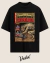 Black oversized t-shirt featuring a vintage comic book design of the Chupacabra, depicting a creature attacking a goat with a retro horror theme.