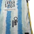 Camisa Málaga I 2024/25 Torcedor Masculina - Branca e Azul - Athletic Store | Artigos Esportivos