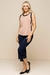 Regata Visco em tom bege com detalhes em azul marinho, combinada com calças capri marinho, formando um look casual confortável e elegante.