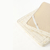 Colchón Pillow Top de látex natural de 6 cm, plegado, mostrando elásticos para sujetar y base 
