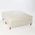 Sommier Naturalfoam 2 plazas con colchón, tapizado en color claro con patas de madera.