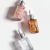 Três frascos de vidro com conta-gotas contendo Blindagem Seal Pro Incolor e versões com brilho da Lara Beauty sobre fundo branco