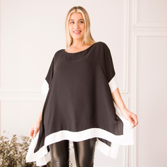 Blusa Gio en color negro con detalles en blanco, modelo luciendo la prenda.