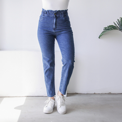 Jean baggy de tiro alto con detalle fruncido en la cintura, combinado con zapatillas blancas.