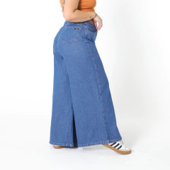Jeans Gotic de tiro alto, anchos y de color azul, modelados por una persona de perfil.