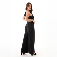 Modelo luciendo un mono negro con un hombro al descubierto, ideal para ocasiones elegantes.