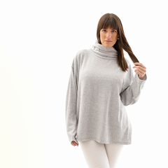 Poncho polera gris de mujer con cuello alto, luciendo elegante y cómodo.