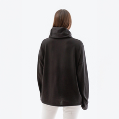 Poncho polera de color negro visto desde atrás, con un diseño cómodo y moderno.