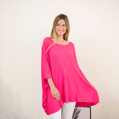 Remerón Alma morley en color fucsia, con manga corta y diseño amplio, presentado por una modelo sonriente.