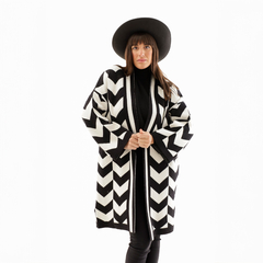 Saco Maya de diseño chevron en blanco y negro, modelo con sombrero, posando en un fondo blanco.