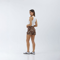 Modelo luciendo un short cargo de estampado animal, de espaldas, en un fondo blanco.