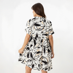 Vista trasera del vestido Griselda, con un diseño abstracto en blanco, negro y dorado.