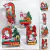 Caixas de acetato decoradas para o Natal, apresentando elementos festivos como Papai Noel, árvores de Natal, presentes e doces em uma composição colorida.