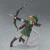 Figura de ação do personagem Link da série The Legend of Zelda, vestindo uma túnica verde e segurando um arco, em pose dinâmica de tiro.