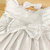 Vestido branco babado duplo laço