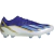 Chuteira de campo Adidas X Crazyfast.1 FG Messi 'Spark Gen10s' em azul profundo e detalhes dourados, homenageando as vitórias da seleção argentina. Uma peça única de história do futebol.