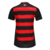 Camisa Flamengo I 2025/26 Feminina Adidas, listrada em vermelho e preto, gola V preta com friso vermelho, ombros pretos com três listras vermelhas da Adidas, escudo CRF branco no peito, logo Adidas branco, numeração e patrocínios em branco nas costas, des