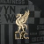 Camisa preta com mosaico em cinza com bandeiras da torcida do Liverpool, listras, quadriculados e as frases "YNWA" e "Strive for greatness". Mangas pretas, gola redonda e punhos em azul celeste. Logo de LeBron James no lado direito do peito, escudo do Liv