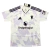 Camisa reserva do Manchester United 2025-2026, branca com detalhes lilás e roxos, design inspirado em flocos de neve, gola em V, logotipo do diabo.