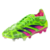 Chuteira Adidas Predator 24 Lowcut FG Generation verde, rosa e roxa em pé sobre grama verde. A chuteira tem um design leve e respirável com uma combinação de cores verde solar e rosa choque acentuada por um gráfico de leopardo.