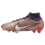 Chuteira Nike Mercurial Mbappé France 2022 World Cup - Edição Especial Copa do Mundo em pé sobre fundo branco. A chuteira é predominantemente azul marinho com detalhes em dourado e branco. O símbolo da Nike está em dourado no calcanhar e o nome "Mbappé" e