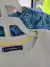 Set: 2 remeras MC blanca c palmeras azules + celeste c hojas azules - MIMO - Talle M (6a9 meses) - Lo Canto
