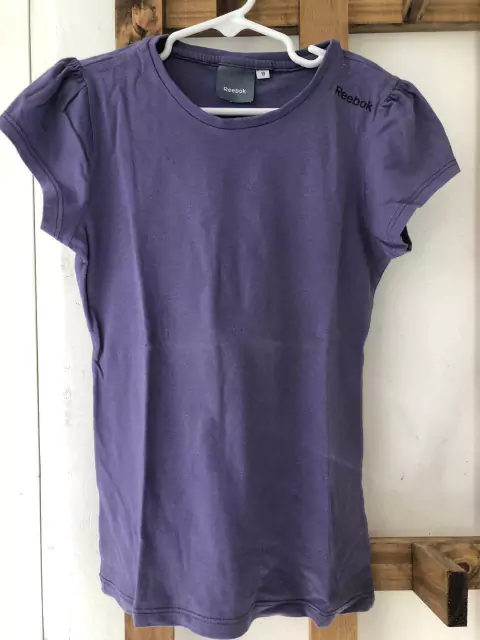 6A | Outlet- Remera MC lila. Reebook. Dice talle 10 pero es más 6 años.