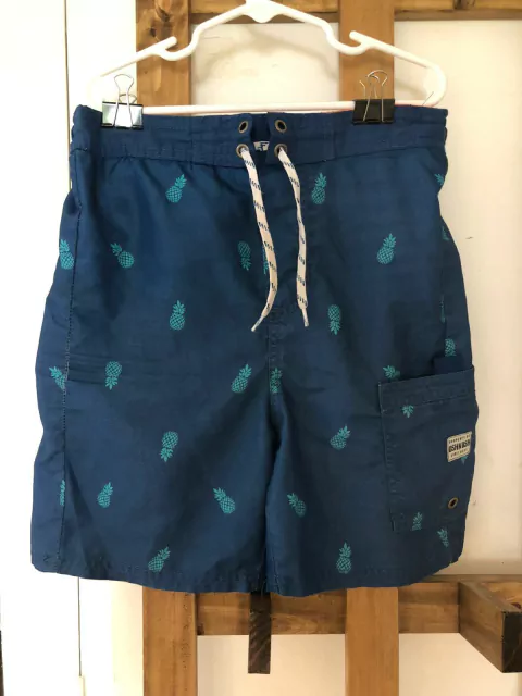 8A | Traje de baño azul con ananás. OSHKOSH. Talle 8 años.