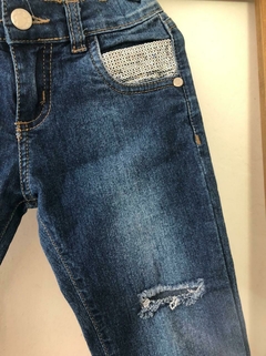 Jean azul con roturas y lentejuelas plateadas. Figurinha. Talle 6. La cintura mide 24 cm. - comprar online