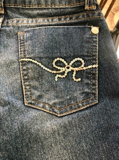 Jean azul con roturas y lentejuelas plateadas. Figurinha. Talle 6. La cintura mide 24 cm. - Lo Canto • Moda Circular